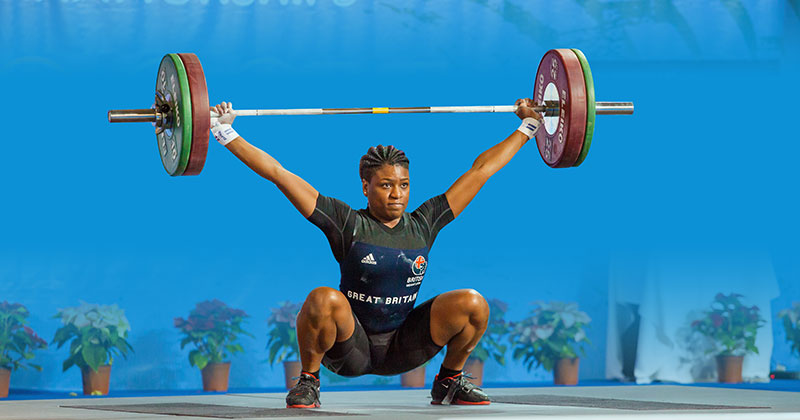A lady performing an olympic lift